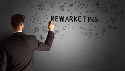 businessman drawing a creative idea sketch with REMARKETING inscription, business strategy concept