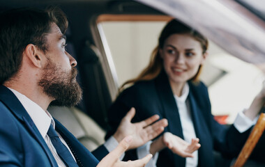 business man and woman sitting in a car salon communication emotions