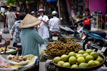 Hanoi Vietnam Busy Street Fruit seller, fresh food market, motorbikes
