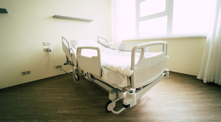 Modern recovery electronic bed in the big white hospital ward