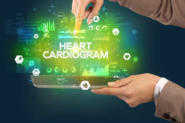 Close-up of a touchscreen with HEART CARDIOGRAM inscription, medical concept