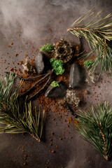 Top view of beautiful molecular modern cuisine dish decorated with wooden sticks and pine branches.