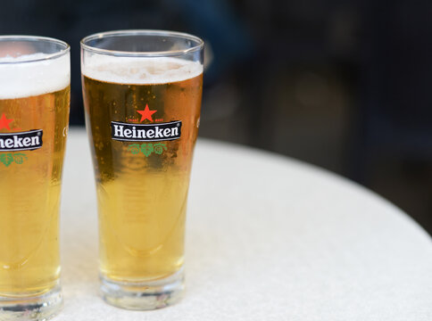 MILAN, ITALY - SEPTEMBER 10, 2016: Two glasses of Heineken pilsener, a Dutch brand of lager beer since 1873, produced and distributed in over 30 countries