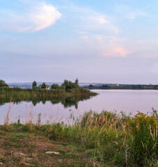 Evening dusk on summer valley lake. Natural seasonal, weather, countryside beauty concept and background scene.