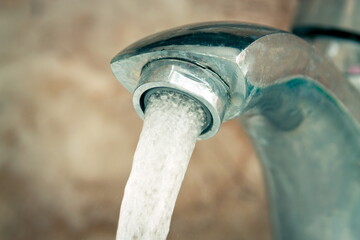 Closeup of the flowing water from the tap
