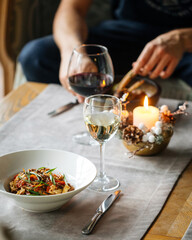 Man dining with gourmet dishes and wine sitting on the sofa
