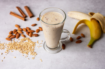 Healthy fresh vegan oat smoothie with almond nuts and bananas. Concept for healthy food. Selective focus. 