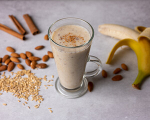 Healthy fresh vegan oat smoothie with almond nuts and bananas. Concept for healthy food. Selective focus. 