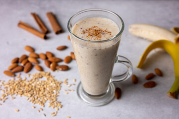 Healthy fresh vegan oat smoothie with almond nuts and bananas. Concept for healthy food. Selective focus. 