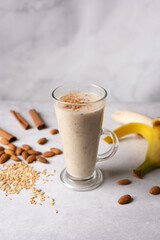 Healthy fresh vegan oat smoothie with almond nuts and bananas. Morning breakfast. Selective focus. 