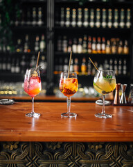Side view on three glasses of different fruit cocktails on the bar desk