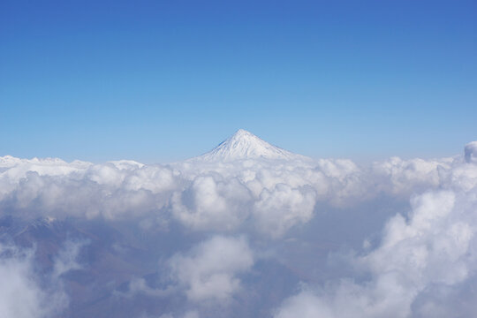 The magnificent Damavand peak surrounded by clouds captured in Iran