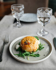 Baked camembert cheese in puff pastry on the served table
