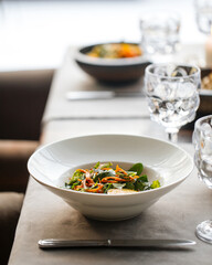 Table served with a bowl of pan asian dish with vegetables