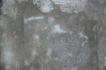 fragment of an old brick wall with concrete plaster and remnants of multicolored paint, grunge,...