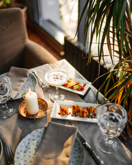 Side view on restaurant table served with European fusion cuisine appetizers