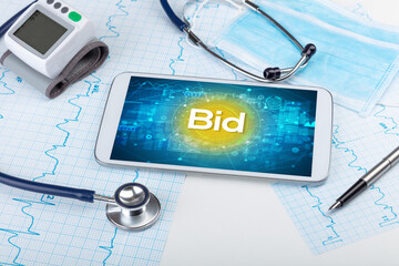 Close-up view of a tablet pc with Bid abbreviation, medical concept