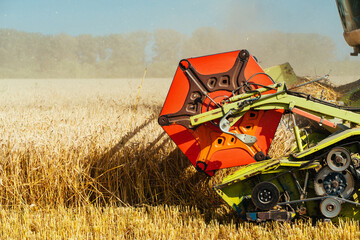 Combine harvester harvests ripe wheat. Concept of a rich harvest. Agriculture image