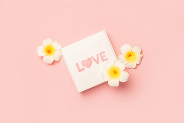 Gift box and flowers on a pastel pink background. Composition Valentine's Day. Flat lay, top view. Banner