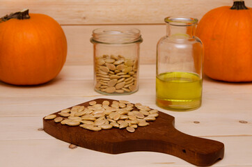 fruits and seeds of pumpkin seed oil on wooden background 