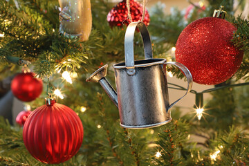 Christmas tree ornament pewter watering can surrounded by red baubles
