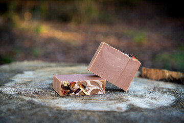 Fresh bar of natural handmade soap presented in the forest