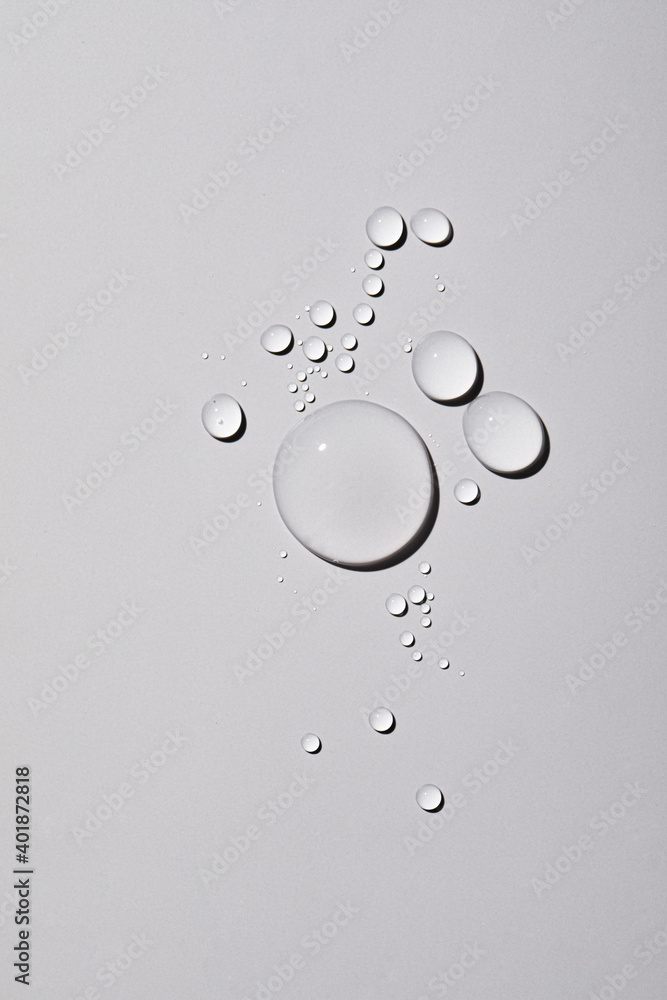 Poster a top view closeup of multiple water drops on a light grey background