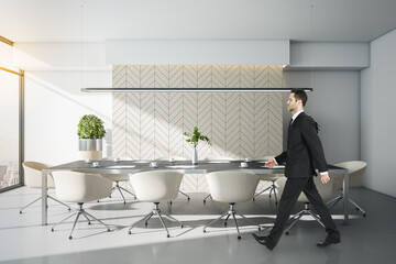 Businessman walking in stylish conference room