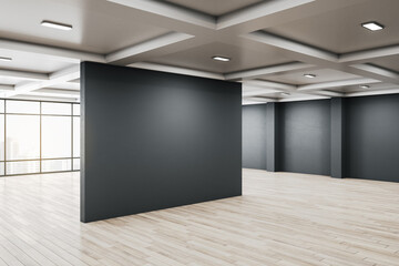 Clean gallery interior with empty black poster and city view
