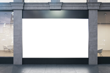 Store with blank poster on vitrine and columns.