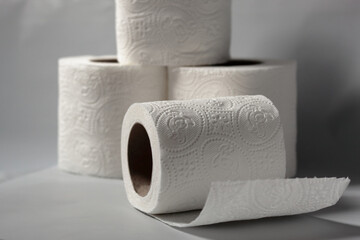four white toilet paper rolls on the white background