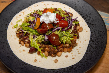 A plate of delicious smoky vegan chilli in a wrap