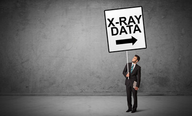 Fototapeta na wymiar business person holding a traffic sign with X-RAY DATA inscription, new idea concept