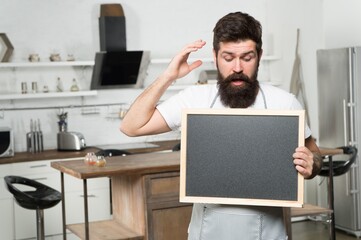 mature handsome man barista with empty blackboard, copy space, coffee time