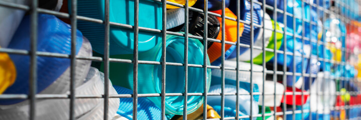 Selective focus view on plastic bottle caps collected for recycling. Ecology, environmental protection concept. Plastic waste. Wide banner. Copy space