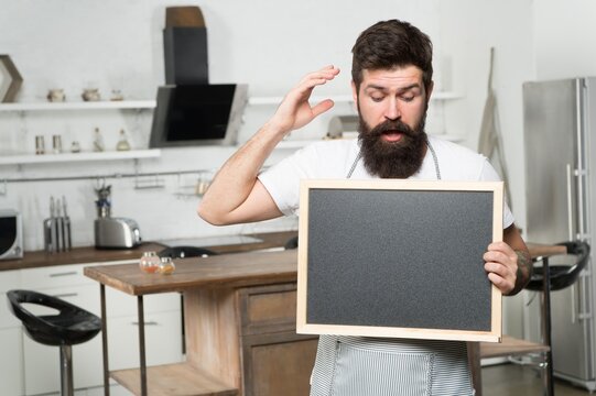 mature handsome man barista with empty blackboard, copy space, coffee time - Powered by Adobe