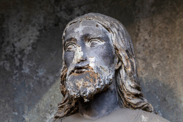 Fototapeta na wymiar Historic Jesus on the winter mystery old Prague Cemetery, Czech Republic