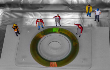 Engineers examine square optic disc card