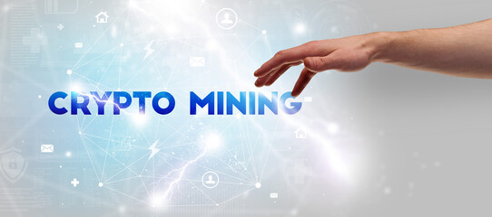 Hand pointing at CRYPTO MINING inscription, modern technology concept