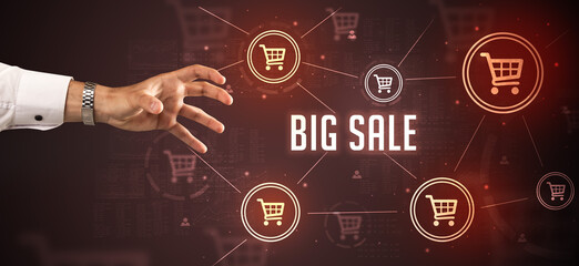 Close-Up of cropped hand pointing at BIG SALE inscription, online shopping concept