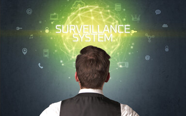 Rear view of a businessman with SURVEILLANCE SYSTEM inscription, online security concept
