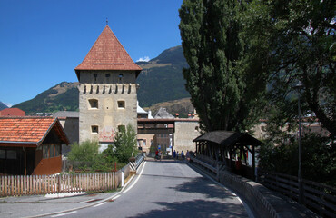 Fototapeta na wymiar Medieval Tauferer Tor city gate with a covered bridge in the old town of Glurns in Vinschgau region, South Tyrol in Italy