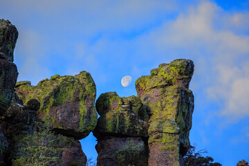Rhyolite formations create a natural frame for a rising moon at Chiricahua National Monument in southern Arizona..