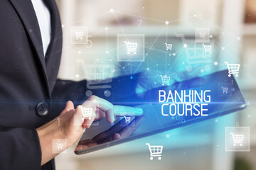 Young person makes a purchase through online shopping application with BANKING COURSE inscription