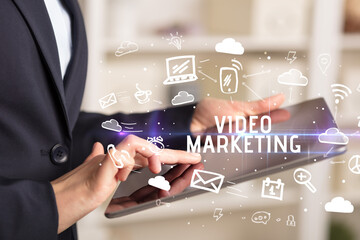 Close-up Of A Person Using Social Networking with VIDEO MARKETING inscription