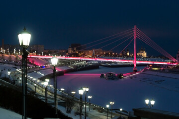 Pedestrian bridge on the embankment in Tyumen, Russia, at night, in winter
