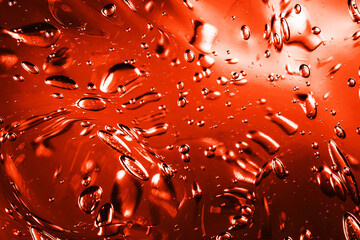 Red water gel background. Abstract round bubble shapes fizzy liquid pattern. Water fluid red texture. Bright back light spa water. Abstract fluid jelly background.