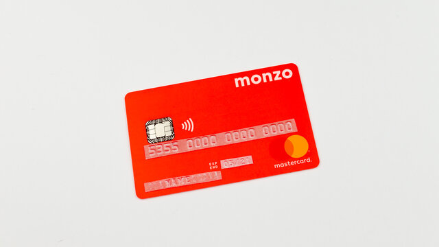 Stone, Staffordshire / United Kingdom - May 27, 2019: MONZO bank card photo with stickers on a personal information. One of the first virtual banks