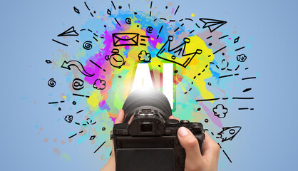 Close-up of a hand holding digital camera with abstract drawing and AI inscription