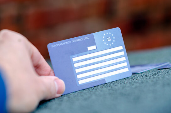 Stone, Staffordshire / UK - October 13 2019:  Blank European Health Insurance Card Hold By Hand. The EHIC Card Covers You Against Illness Or Injury In Europe. Photo With Selective Focus.